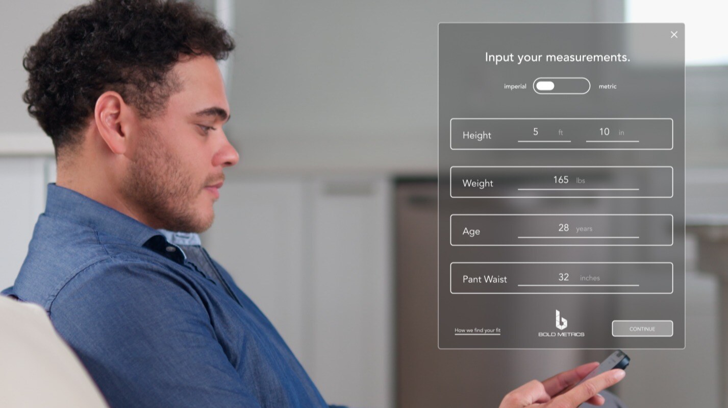 A man using his phone to input his measurements into Bold Metrics' smart size chart